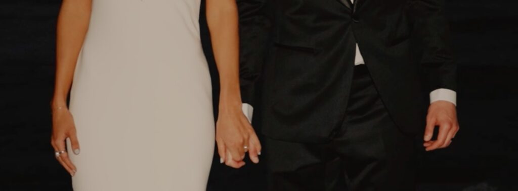 a woman in a white dress and a man in a black suit